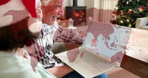 Senior couple discovering malware on laptop while celebrating cozy christmas at home