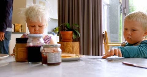 Cute Siblings Having Pancakes Breakfast in Cozy Kitchen