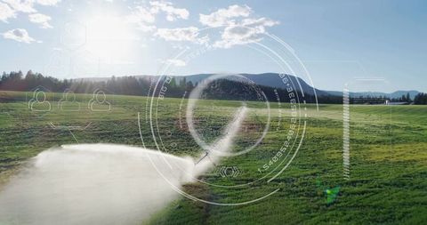 Irrigation sprinkler in field with futuristic hud overlay