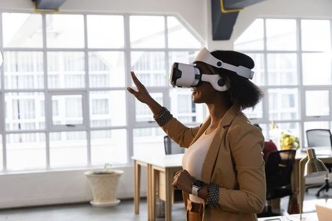 African american businesswoman using vr headset in office for immersive collaboration