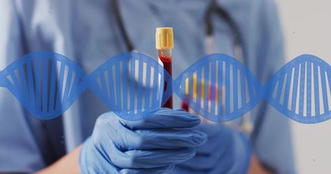 Scientist holding blood sample with dna graphic in laboratory