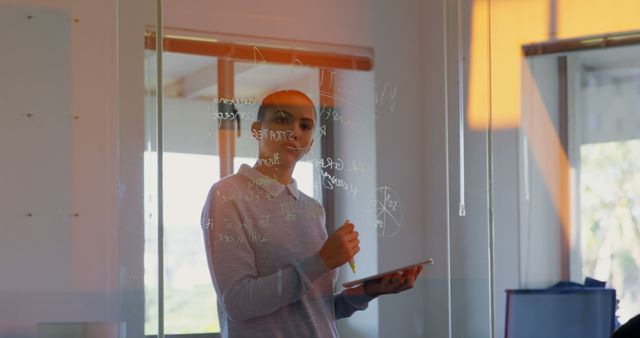 Businesswoman Analyzing Strategy on Glass Board - Download Free Stock Images Pikwizard.com