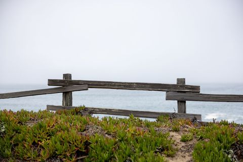 Rustic Wooden Fence Overlooking Foggy Ocean