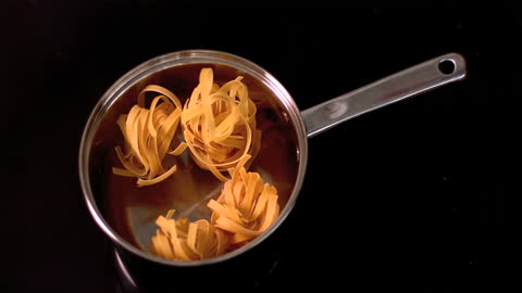 Tagliatelle Dropping into Pan in Slow Motion
