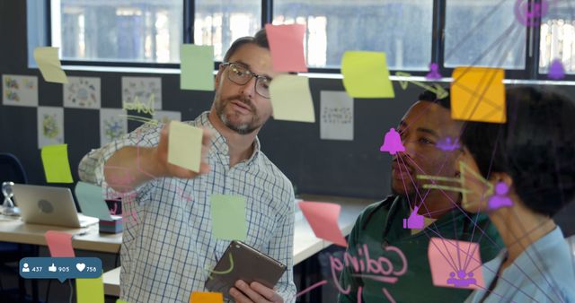 Team Brainstorming Ideas with Sticky Notes on Transparent Board in Office - Download Free Stock Images Pikwizard.com