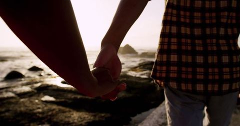 Couple Holding Hands on Scenic Beach at Sunset - Download Free Stock Images Pikwizard.com