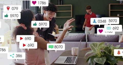 Young professionals high-fiving during coworking collaboration with reaction overlays