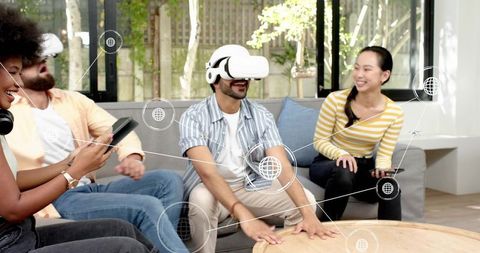 Friends enjoying immersive VR gaming in living room using headset and mobile controllers