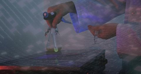 Pipetting neon green liquid into erlenmeyer flask over keyboard with lab coat overlay