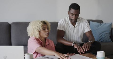 African American Friends Collaborating on Project at Home