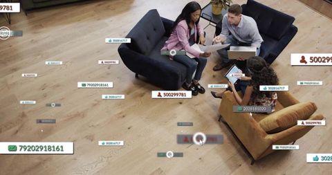 Discussing team collaborating on laptop and tablet with floating annotations and tags