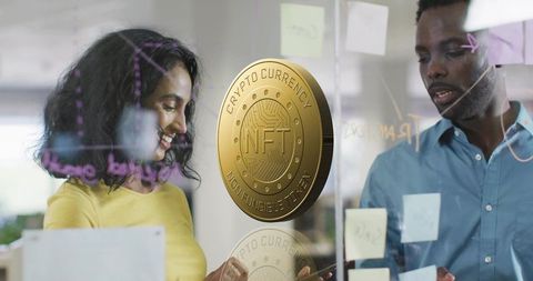 Collaborative nft strategy session on glass board with golden crypto coin reflection