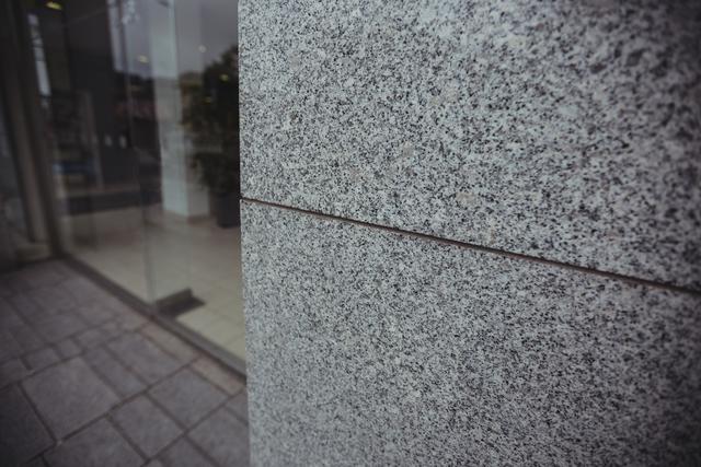 Close-up of a modern granite wall in a commercial building, showcasing the sleek and contemporary design. Ideal for use in architectural presentations, construction material advertisements, urban design projects, and real estate marketing materials.
