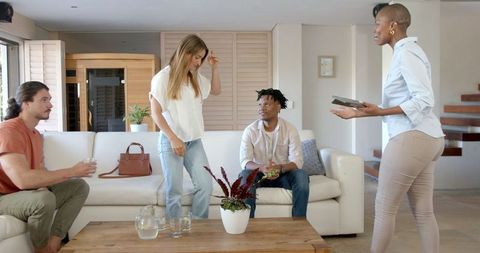 Diverse group of friends engaging in casual apartment conversation