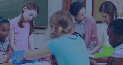 Friendly teacher guiding children in creative drawing activity
