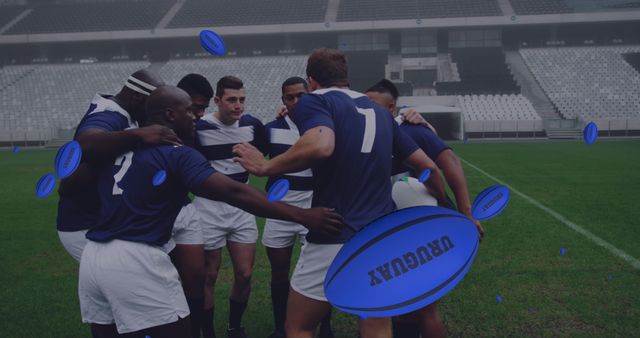 Group of rugby players in blue jerseys huddling on a grass field, forming a strategy during a game. Can be used in sports articles, teamwork and motivation promotions, or athletic fitness ads.