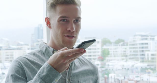 Young Man Using Voice Command on Smartphone Technology Indoors - Download Free Stock Images Pikwizard.com