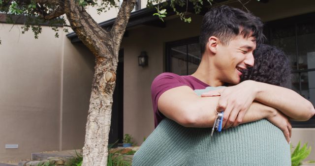 Happy diverse male moving house, holding keys, embracing and smiling - Download Free Stock Photos Pikwizard.com