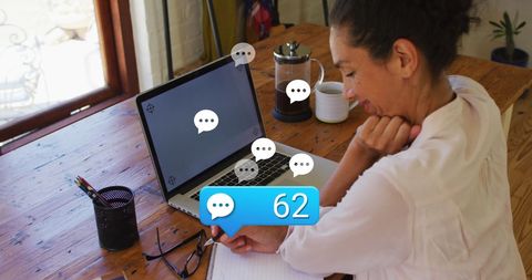 Smiling Woman Engaging in Online Chat on Laptop