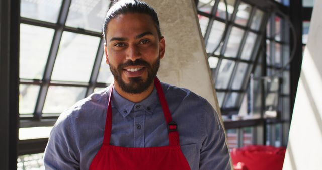 Smiling Chef in Red Apron Standing in Modern Kitchen - Download Free Stock Images Pikwizard.com