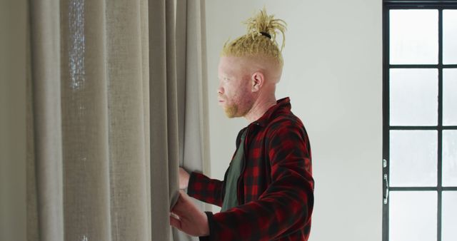 Young Man with Dreadlocks Opening Curtains in Morning Light - Download Free Stock Images Pikwizard.com