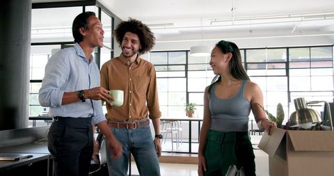 Diverse colleagues unpacking office supplies together