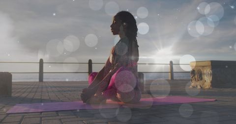 African American Woman Meditating in Sunrise Yoga Session Outdoors