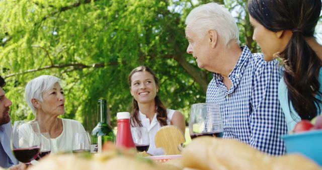 Multi-generational family enjoying outdoor picnic on sunny day - Download Free Stock Images Pikwizard.com