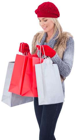Blonde woman carrying shopping bags with red knit hat and sweater