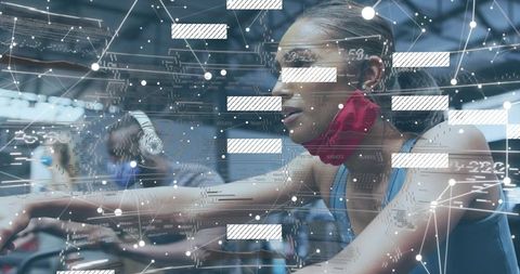 Pedaling woman in spin class with digital fitness data overlay and connected workout tech