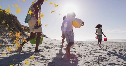 Family Enjoying Day at Sunny Beach Carrying Beach Gear