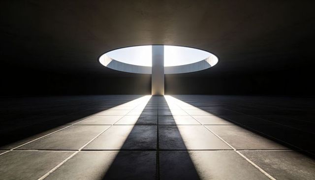 Monolithic Concrete Atrium with Circular Oculus Casting Dramatic Light Shafts