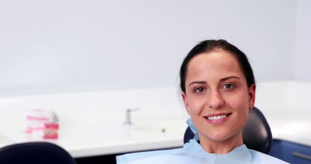 Smiling Woman Wearing Dental Bib in Dentist Office - Download Free Stock Images Pikwizard.com