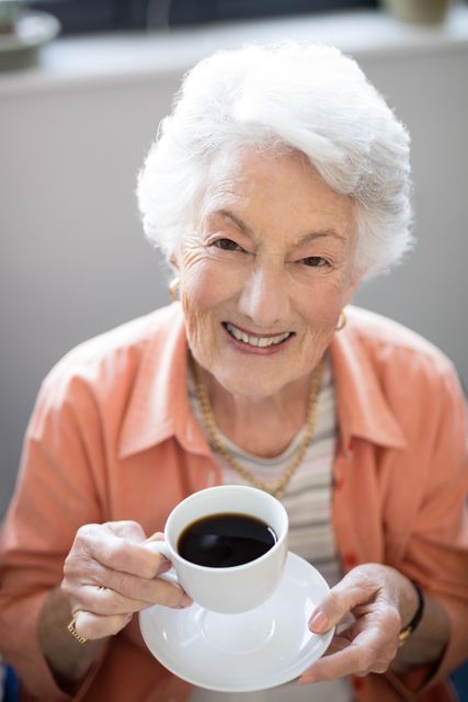 High angle portrait of senior woman holding coffee cup - Download Free Stock Photos Pikwizard.com