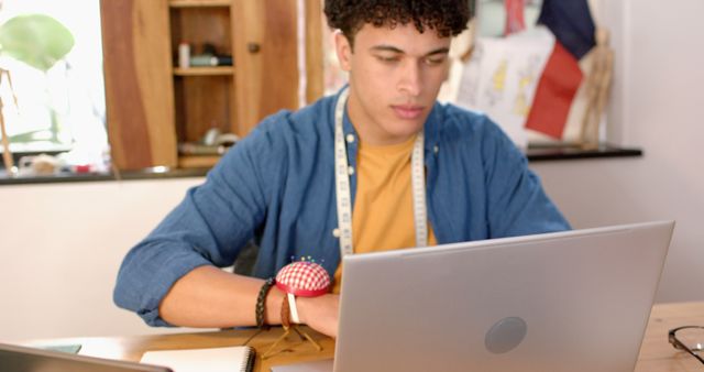 Young Designer Working on Laptop in Fashion Studio - Download Free Stock Images Pikwizard.com