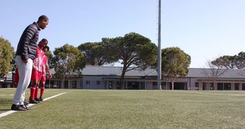Youth Soccer Players Training on Sunlit Field