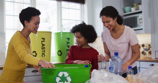 A family of three people is sorting recyclables in a kitchen, including plastic and paper materials. The image is perfect for use in sustainability campaigns, educational materials about recycling, and content focused on eco-friendly living and waste management initiatives.