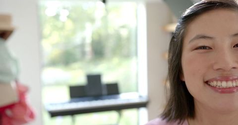 Smiling Woman Relaxing at Home with Piano in Background