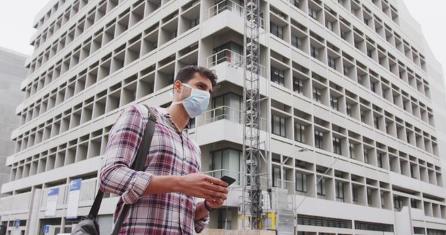 Man Wearing Face Mask Holding Smartphone Near Building - Download Free Stock Images Pikwizard.com