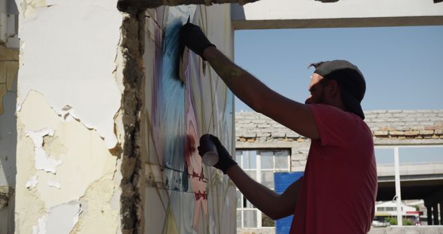 Graffiti Artist Spray Painting Urban Mural on Abandoned Building Wall - Download Free Stock Images Pikwizard.com