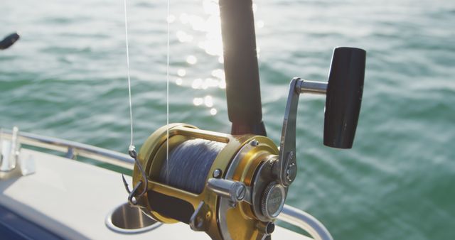 Detail of fishing rods reel onboard fishing boat in the ocean. Leisure, hobbies, travel, water transport and vacations.