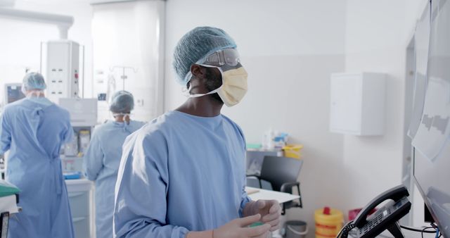 Diverse male and female surgeons with face masks during surgery inspecting board. Medicine, healthcare and hospital, unaltered.