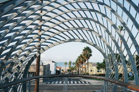 Urban Archway Overlooking Coastal Street with Palm Trees