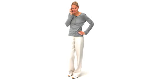 Casual Woman Smiling While Talking on the Phone against White Background