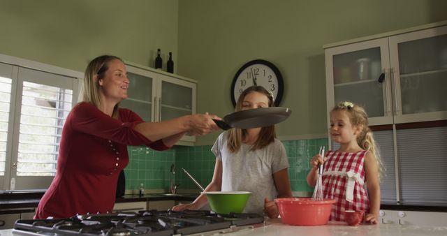 Mother Teaching Daughters to Cook in Bright Kitchen - Download Free Stock Images Pikwizard.com