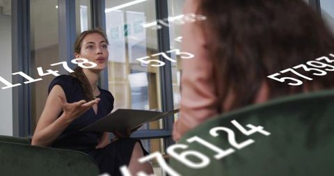 Businesswoman Discussing Data Analytics in Modern Office Environment