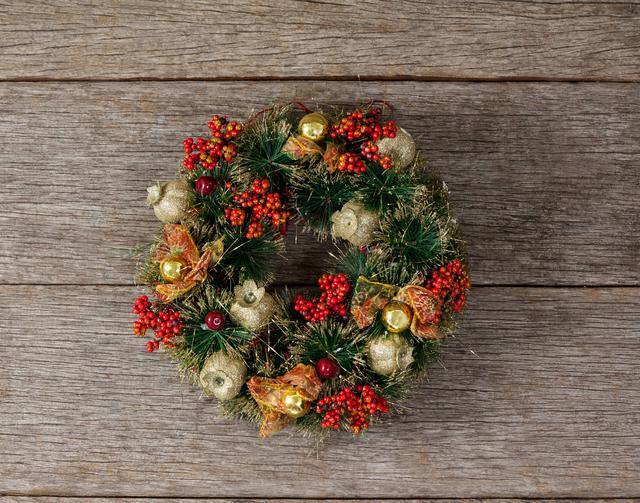 Close-up of christmas wreath on a plank