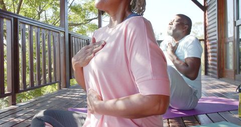 Senior Couple Practicing Yoga Meditation on Sunny Porch