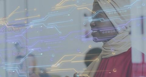 Muslim businesswoman wearing hijab leading tech meeting with digital circuit overlay