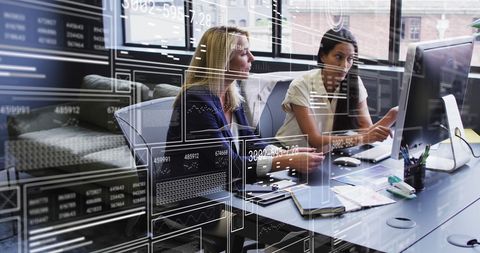 Businesswomen Discussing Reports with Digital Data Overlay